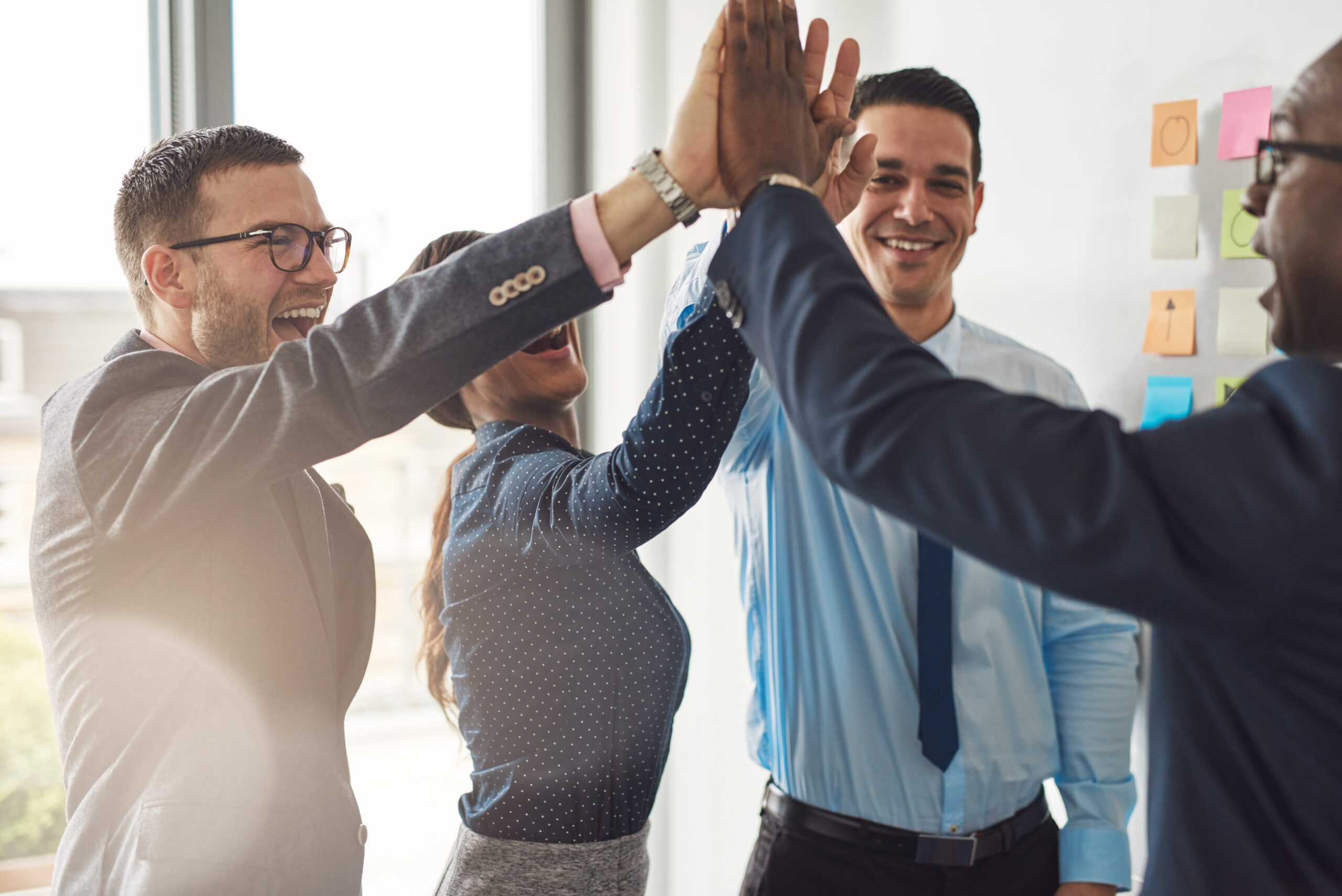 Office coworkers high five - great business success